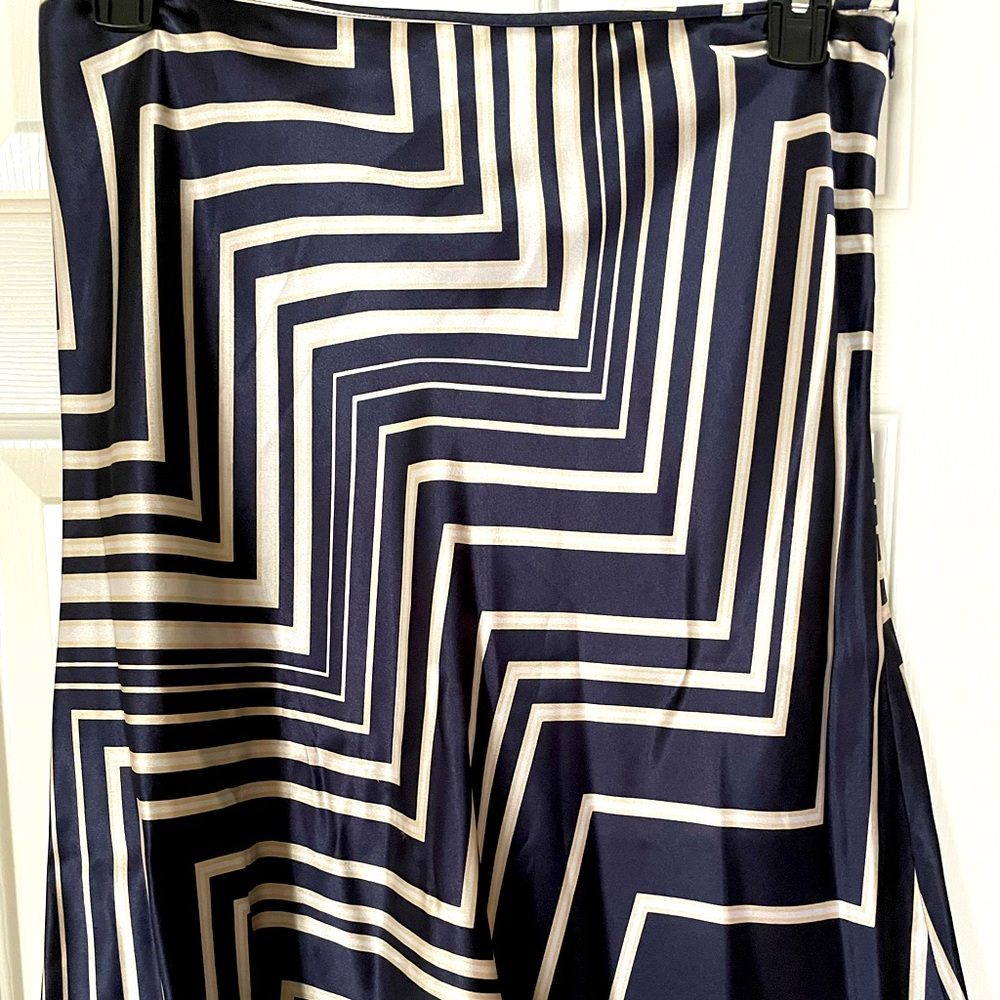 Navy blue A-line skirt with cream colored geometric pattern. Size 12